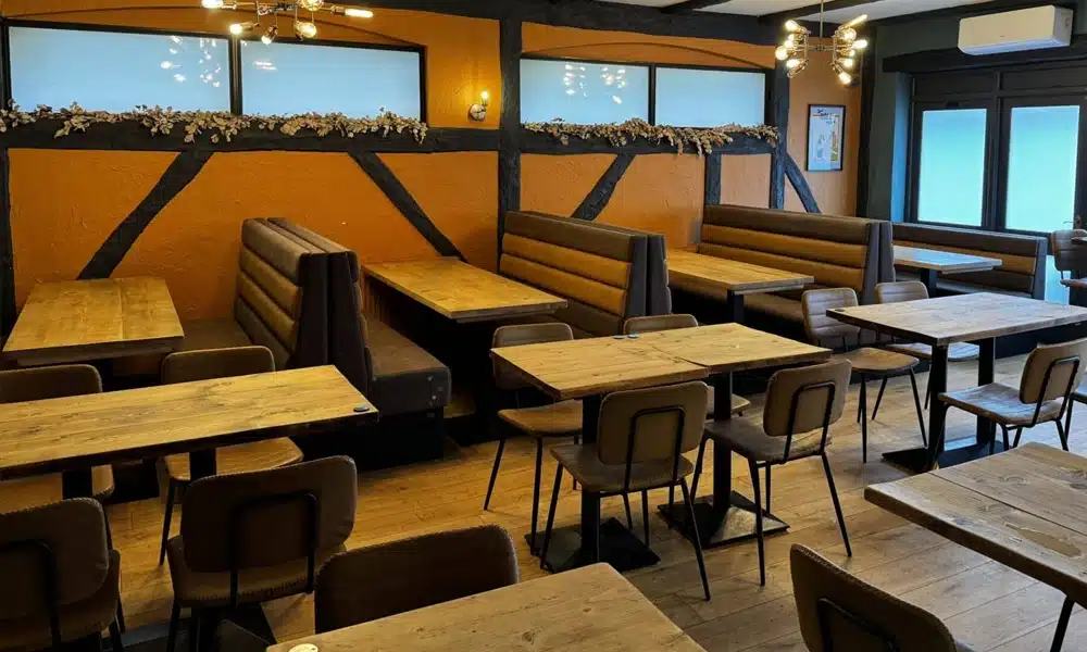Wide view of Legra Tap & Kitchen restaurant interior with horizontal fluted booth seating and solid oak table tops.