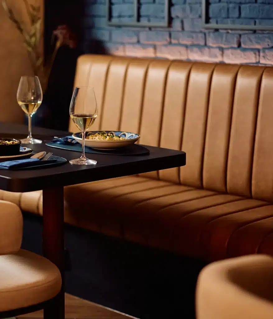 Booth seating with fluted stripes in a lovely moody bar
