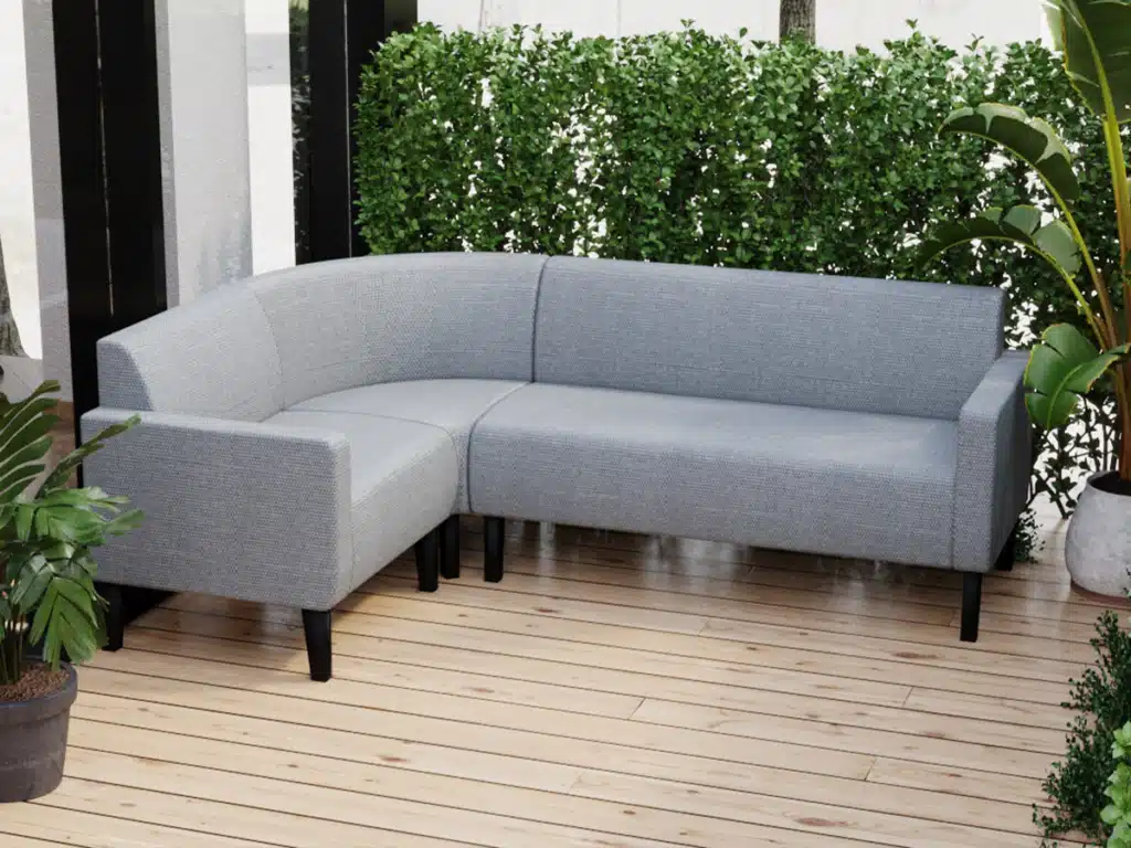Rounded Booth Set L Shaped in a exterior patio area, lots of green plants around