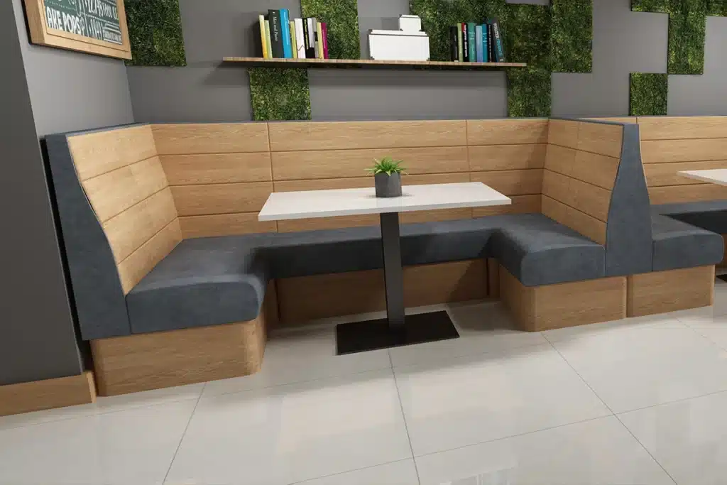 Plank-back booth seating in a cafe environment with vertical wood laminate slats and upholstered seat, showing a laminate-backed banquette design for cafés and restaurants.